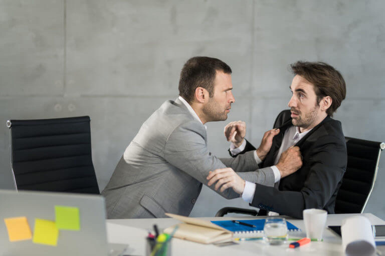 Angry businessman attacking his employee in the office