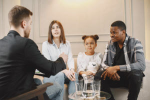 Family with daughter having a test at therapist