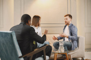 Couple at pshycologist appointment sitting in modern office